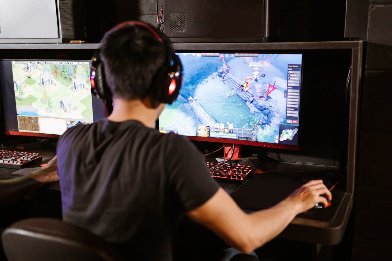 a person sitting behind a PC figuring out strategy games that they like image source: https://www.pexels.com/photo/man-playing-computer-game-7915281/